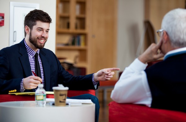 Matt Perejda ‘14 of Newry, Maine, talks with Stangle during a one-on-one meeting in Fireplace Lounge in Commons on March 5, 2014. (Sarah Crosby/Bates College)