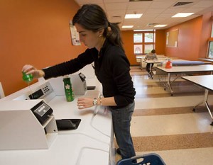 Painted a cheerful orange, the laundry room at the 280 College St. residence is a popular hangout. Shown in this file photo are Halley Eliot '08 (foreground) and  Kaitlin Wellens '11. (Phyllis Graber Jensen/Bates College)