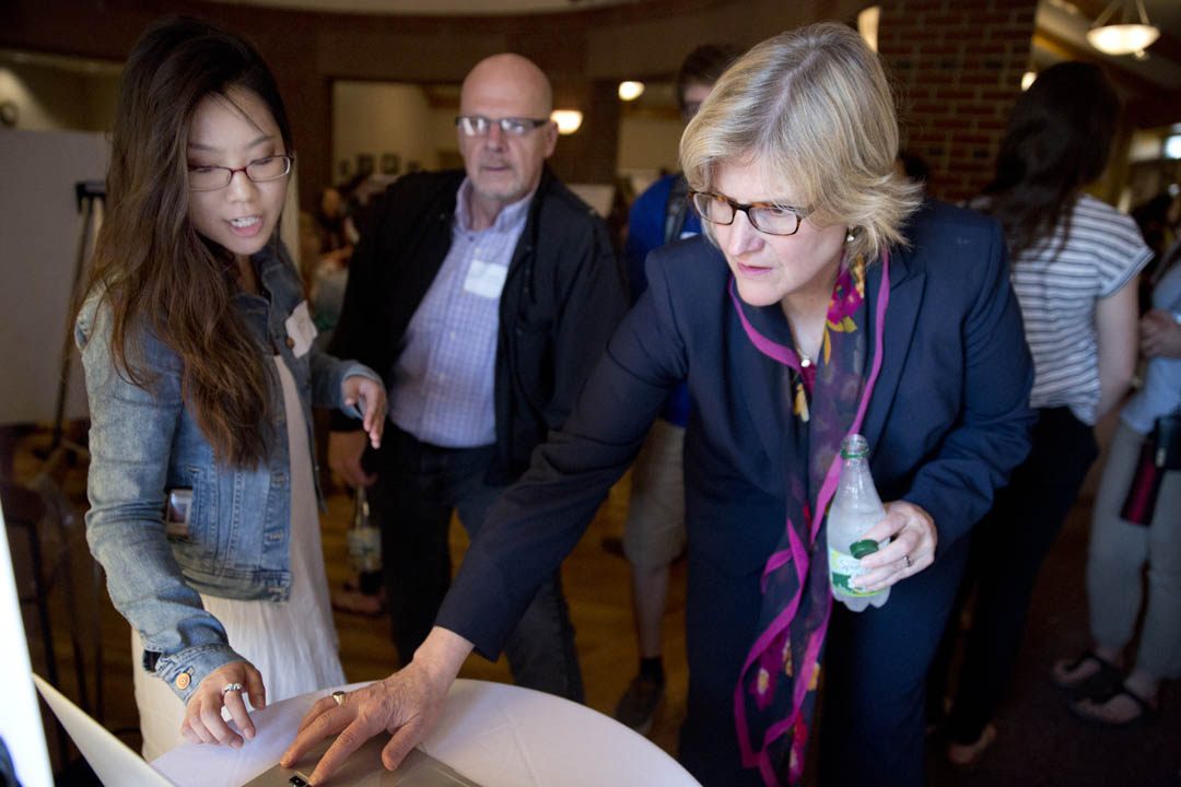 Held every Short Term, the Short Term Curricular Innovation Showcase reveals what students have achieved in Practitioner-Taught and STIP courses. Shown in 2015, Hyo Sun Hong '16 explains a graphic design project to President Clayton Spencer and Professor of Russian Dennis Browne. (Phyllis Graber Jensen/Bates College)