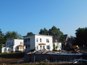 At right, the power shovel gnaws at 75 Campus Ave. in this image from Aug. 5, 2014. (Doug Hubley/Bates College)