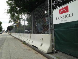 Replacing a provisional fence around the Campus Life Project site the week of Aug. 11, this fence will remain for the duration of the construction. (Doug Hubley/Bates College)