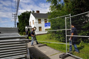 Workers erect fencing around the Campus Life Project site at Central and Campus avenues on July 29, 2014. (Phyllis Graber Jensen/Bates College)