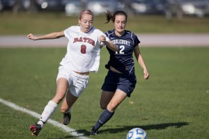 September is a big soccer month. In this image from last season, Leah Humes '16 and a Middlebury player vie for the ball. (Phyllis Graber Jensen/Bates College) and Phyllis shot it.