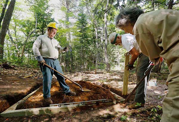 Lester Kenway '75 works along the Appalachian Trail in Caratunk, Maine, alongside wife Elsa Sanborn and Craig Dickstein.