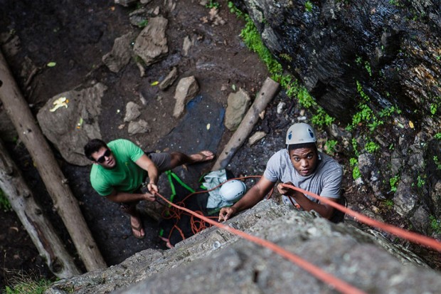 A few days before Convocation, Kwamae Delva '18 of Conley, Ga., begins his ascent of a rock wall in Rumney, N.H., as student leader Sean Enos '15 of Lynnfield, Mass., provides belay. The trip was one of many enjoyed by groups of first-years as part of AESOP, the Annual Entering Student Outdoor Program. (Sarah Crosby/Bates College)