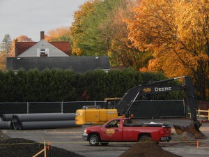 At lower left, the pipes stacked in the Franklin Street parking lot will someday carry storm runoff away from the Campus Life Project residences. (Doug Hubley/Bates College)