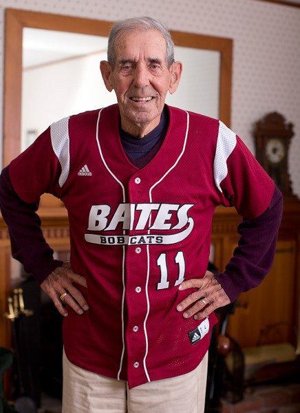 William "Chick" Leahey '52 dons his No. 11 Bates jersey at his home on East Avenue. His jersey will be retired Saturday at halftime of the Homecoming football game vs. Colby. (Phyllis Graber Jensen/Bates College) 