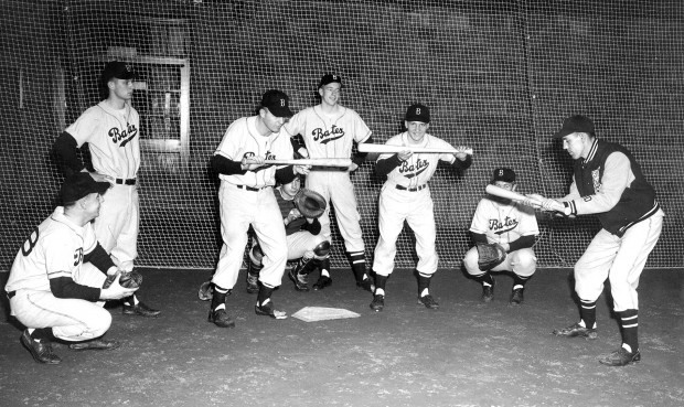 Chick Leahey (right) runs a bunting drill during an early spring practice in the Gray Athletic Building. (Photo courtesy of the Edmund S. Muskie Archives and Special Collections Library)