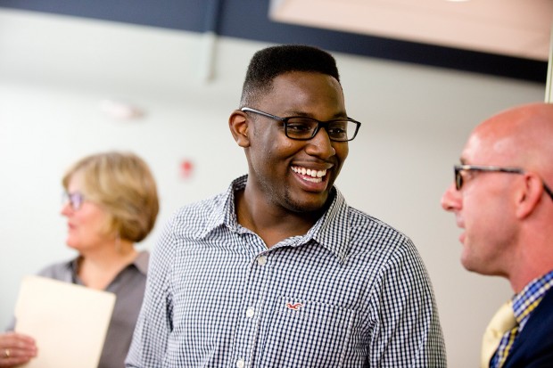 Jalen Baker '16 of Lancaster, Texas, talks with Dean of Students Josh McIntosh during the reception celebrating the new home of the Office of Intercultural Education. (Phyllis Graber Jensen/Bates College)