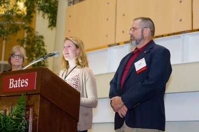 Jeff Sturgis '69, recipient of the David G. Russell Award for outstanding admission volunteer work, stands by as Dean of Admission Leigh Weisenburger reads the citation and President Spencer listens. (Rene Minnis for Bates College)