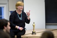 Stacey Kabat '85 talks to students in a film criticism course taught by Jonathan Cavallero, assistant professor of rhetoric. She brought along her Academy Award because "it's fun to hold it, so I always feel like sharing." Students passed it around and, yes, it's heavy. (Phyllis Graber Jensen/Bates College)