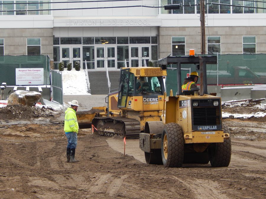 With the entrance to Lewiston Middle School in the background, workers for Gendron & Gendron prepare a parking area on the 65 Campus Ave. site. (Doug Hubley/Bates College)