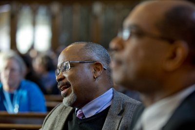 Marcus Bruce, Benjamin E. Mays Distinguished Professor of Religious Studies, and Associate Dean of Students James Reese listen to the MLK Day keynote address. (Phyllis Graber Jensen/Bates College)