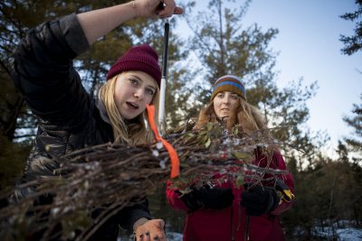 Bates students Kat Harling '17, left, and Grace Boueri '16 weigh twigs in Garcelon Bog, an im-portant wetland in Lewiston, as part of carbon-sequestration research carried out by a Bates College environmental studies course. (Sarah Crosby/Bates College) weigh a packet of twigs in Garcelon Bog, an ecologically significant wetland in Lewiston. The shrub clippings and other plant samples will be used to figure out how much carbon is sequestered in the bog in the project conducted in Holly Ewing's environmental studies course Scientific Approaches to Environmental Issues. (Sarah Crosby/Bates College)