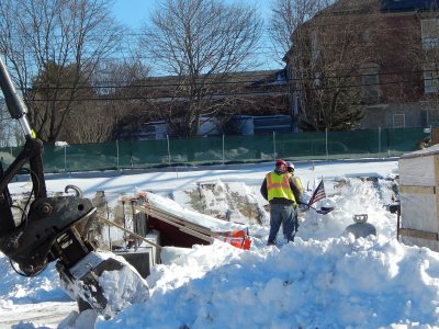 Construction workers clear snow from the foundation-in-progress of the 65 Campus Ave. residence on Jan. 29. (Doug Hubley/Bates College)
