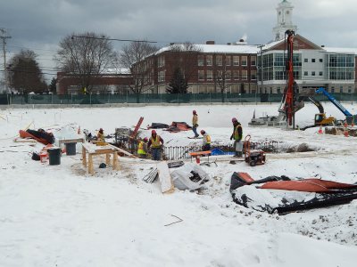 While Helical Drilling machinery, at right rear, sinks Geopiers, other workers tend to concrete footings for the 65 Campus Ave. residence on Jan. 9, 2015. (Doug Hubley/Bates College)