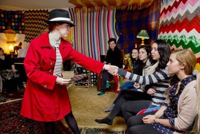 Directed by Nick Auer '15 (at rear), the Bates production of "The Breasts of Tiresias" provides an immersive audience experience. In the red coat is Hope French '18. (Phyllis Graber Jensen/Bates College)