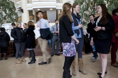 Students chat and crowds move through the Perry Atrium at Bates College during the 2014 Mount David Summit. (Sarah Crosby/Bates College)