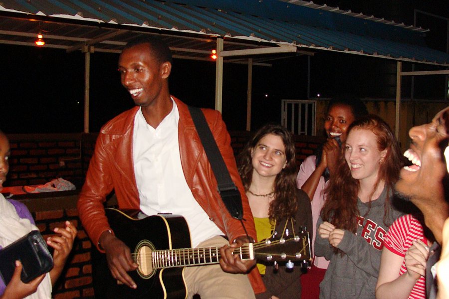 Bates students and survivors gather for music and fellowship during the 2013 Short Term. "Interactions with survivors of genocide is not only about the past and grievance but also about sharing laughter within the present despite of it all.The attached picture features 