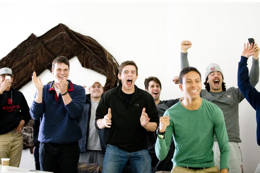 Students watching a livestream in Commons react as Ahmed Abdel Khalek ‘16 of Cairo, Egypt, scores the winning point in the men's individual collegiate squash championship on March 1. (Phyllis Graber Jensen/Bates College)