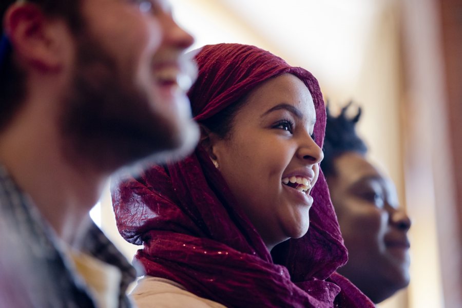 Keenan Shields '18 of Pittsford, N.Y., Rakiya Mohamed '18 of Auburn, Maine, and Christina Olali '18 of New York City respond to a story by Patrick Sheehan '18 of Weymouth, Mass., during a storytelling event sponsored by the Office of Intercultural Education at the Benjamin Mays Center. The storytellers chose from "The Hidden Heart" and "Fish Out of Water" themes. (Phyllis Graber Jensen/Bates College)