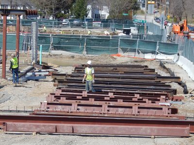 A rigger for Stellar Steel looks for the next piece of the 65 Campus Ave. metal to give to the crane on April 22, 2015. Note the markings on the components that specify where and in what order they will be placed. (Doug Hubley/Bates College)