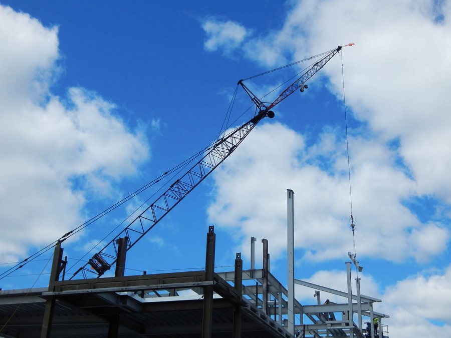 The crane lowers a piece of steel into place at 65 Campus Ave. on May 13, 2015. (Doug Hubley/Bates College)