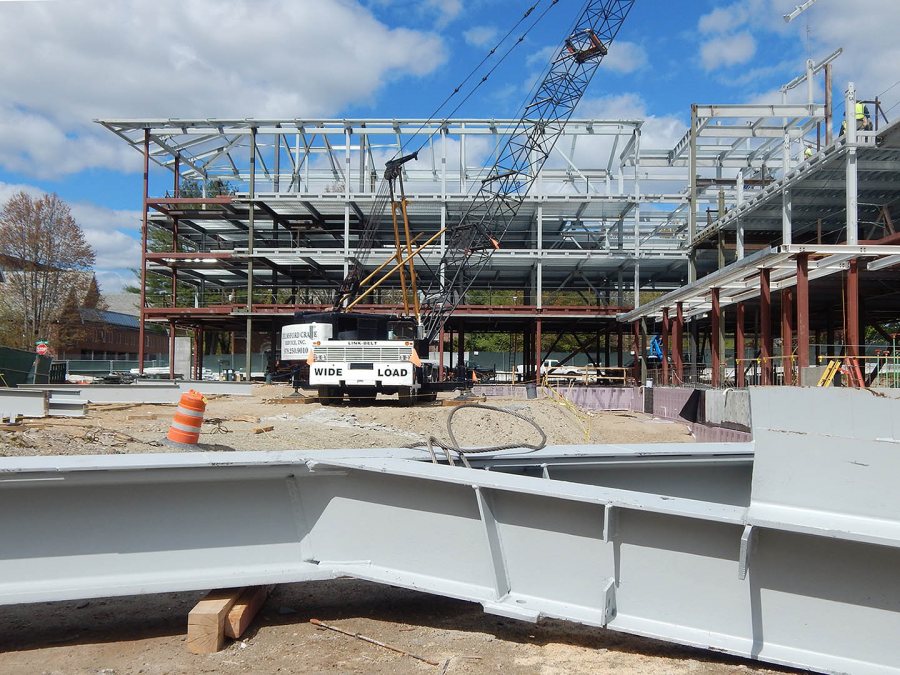 With a piece of structural steel in the foreground awaiting its ride in the sky, the skeleton of the 65 Campus Ave. student residence is shown on May 13, 2015. (Doug Hubley/Bates College)