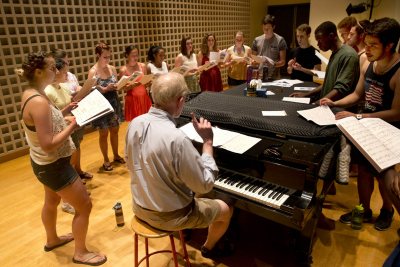 John Corrie rehearses the Commencement choir on the stage of the Olin Arts Concert Hall on May 27. They will sing "For Good" from the musical "Wicked." (Phyllis Graber Jensen/Bates College)