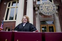 On the Coram Library porch, Bates Registrar Mary Meserve checks the diplomas one last time just prior to Commencement 2014. (Phyllis Graber Jensen/Bates College)