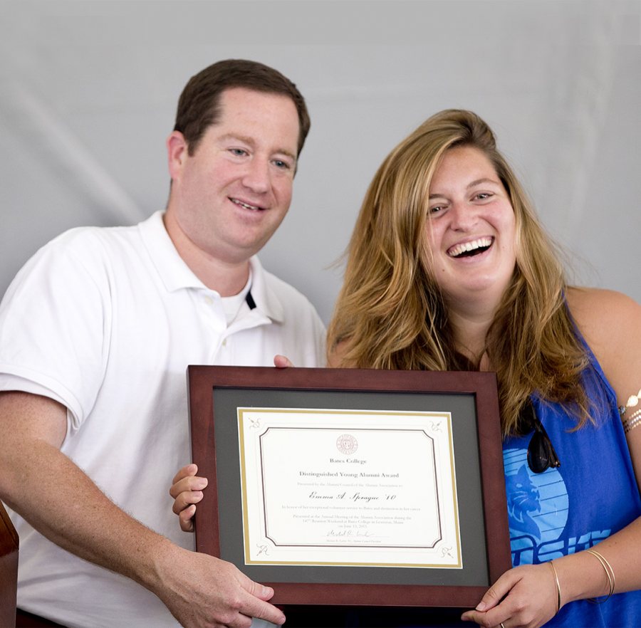 Emma Sprague '10 accepts the Distinguished Young Alumni Award from Mike Lieber '92, president of the Alumni Association, at Reunion on June 13, 2015. (Phyllis Graber Jensen/Bates College)