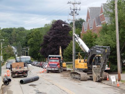 This July 24 image depicts a familiar sight at Bates in July 2015: utility crews performing open-tar surgery on Campus Avenue while traffic finds a way around. (Doug Hubley/Bates College)