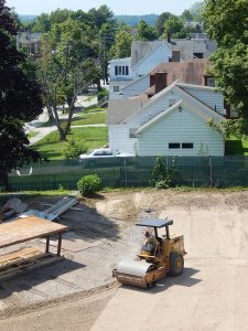 The zoom lens compresses the view and the vibratory roller compresses the soil behind 65 Campus Ave. on July 28, 2015. (Doug Hubley/Bates College)