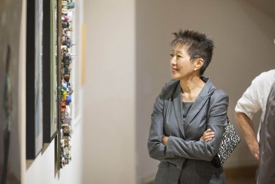 The NEA's  Jane Chu admires a piece the Bates Museum of Art exhibition "Maine Collected." (Josh Kuckens/Bates College)
