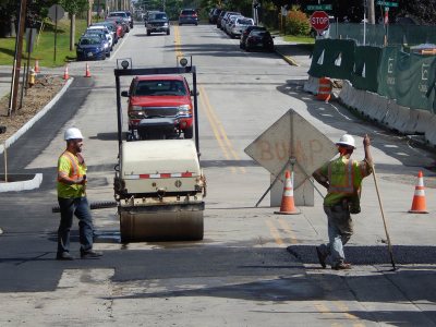 For much of July and August, 2015, Campus Avenue was closed for utilities work related to the Campus Life Project. In this image from Aug. 13, pavers tamp down new asphalt. (Doug Hubley/Bates College)