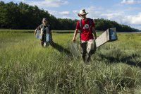 Cailene Gunn '16 of Granby, CT and Dana Cohen-Kaplan '16 of Newton, MA exit Long Marsh in Harpswell, ME after a sun-soaked afternoon of work. Gunn and Cohen-Kaplan have been conducting field research at Morse Mountain this summer under the supervision of Geology professor Beverly Johnson.