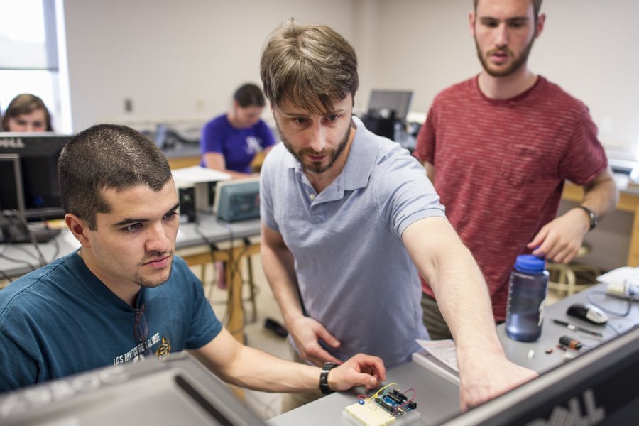 Assistant Professor of Physics Travis Gould (center) works with Armando Morales Urrutia '16 (left) of Fraijanes, Guatemala and Daniel Paseltiner '16 of Devon, Pa., during the Short Term course "Microcontroller Laboratory." (Josh Kuckens/Bates College)