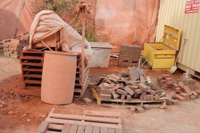 Seeing red: Surrounded by brick dust, a masonry saw on the 65 Campus Ave. work site is covered up for the night. (Doug Hubley/Bates College)