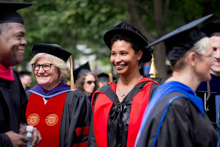 Bates College President Clayton Spencer and Harvard professor Danielle Allen watch as faculty pass before them during Bates' Convocation procession on Sept. 8, 2015. Allen, author of a celebrated study of the U.S. Declaration of Independence, gave Bates' Convocation address. (Phyllis Graber Jensen/Bates College)