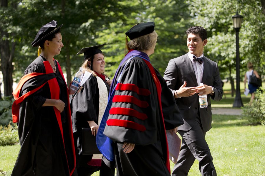 Bates' 2015 Convocation speakers -- keynote Danielle Allen, multifaith chaplain Brittany Longsdorf, Bates President Clayton Spencer, and Student Government President Berto Diaz '16 -- cross the Historic Quad during the event. (Phyllis Graber Jensen/Bates College)