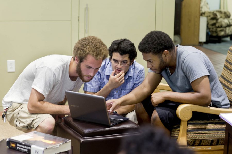 From left, physics major Dan Paseltiner ’16 of Devon, Pa., physics major Javier Morales ’16 of Guatemala City, and French major Kwamae Delva ’18 of Conley, Ga. study and socialize in the Office of Intercultural Education. They were discussing anti-derivatives and integrals for a calculus course. (Phyllis Graber Jensen/Bates College)