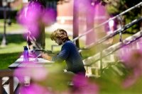 Outside of Roger Williams Hall at lunchtime, Matthew Reback '18 of Potomac, Md., reads Yeats for his modern Irish poetry course. (Phyllis Graber Jensen/Bates College) 