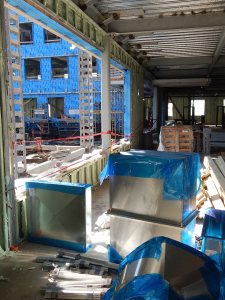 Another view of the entrance lounge at 55 Campus Ave. A fireplace will be installed just past the large window opening. (Doug Hubley/Bates College)