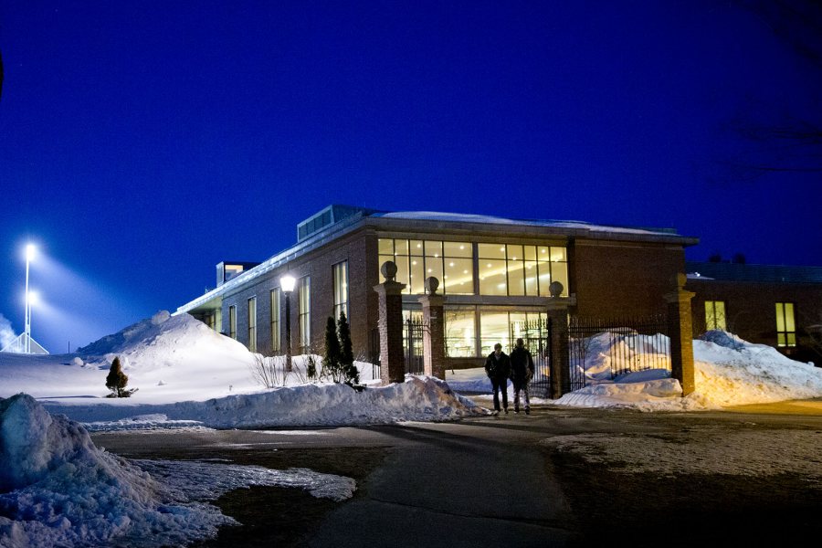 The lights of Garcelon Field illuminate Commons on a March night. Clad in brick, granite, slate, copper, and ample glass, Commons “is not a hip, swinging building but...it has enormous architectural integrity,” said the late architectural critic and author Philip Isaacson ’47. (Phyllis Graber Jensen/Bates College)