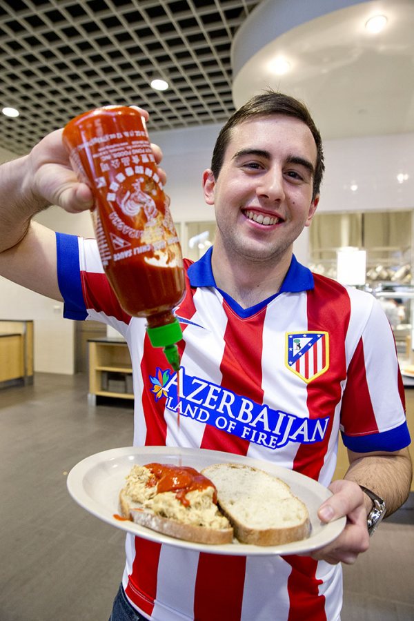 A recent trend in dining? Hot sauces! Thomas Sacchetti ’16 of Princeton, N.J., a physics and math major, loves hot sauce on his chicken sandwich. (Phyllis Graber Jensen/Bates College) 