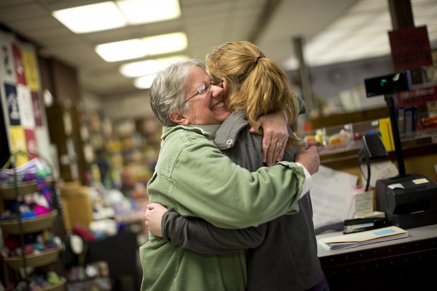 In March of her senior year at Bates, Hallie Balcomb '14 gets a hug from College Store director Sarah Potter '77. (Phyllis Graber Jensen/Bates College) 