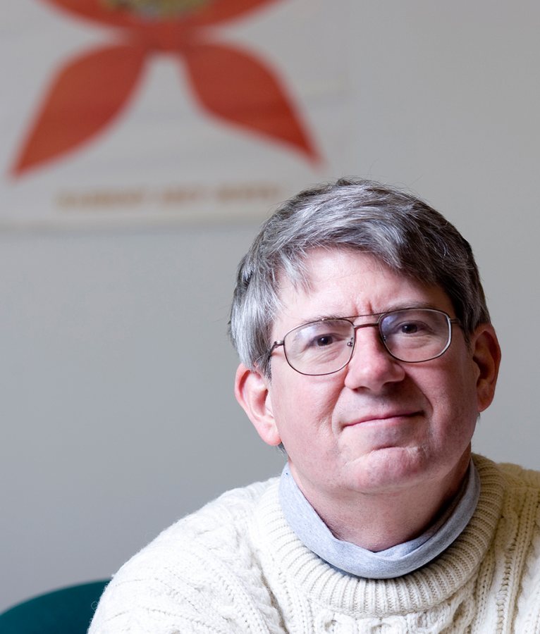 James Richter, an accomplished trombonist as well as a professor of politics at Bates, in his Pettengill Hall office. (Phyllis Graber Jensen/Bates College)