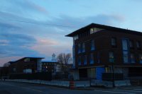 The new student residences at 65 (left) and 55 Campus Ave., seen at dusk Nov. 6, 2015. The cupola in between belongs to Lewiston Middle School. (Doug Hubley/Bates College)