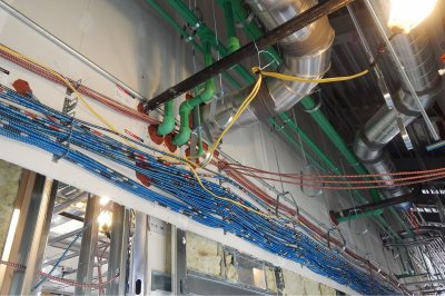 Cables, ducts and pipes will disappear behind the ceiling when 55 Campus Ave. is complete. Photograph taken Dec. 1, 2015. (Doug Hubley/Bates College) 