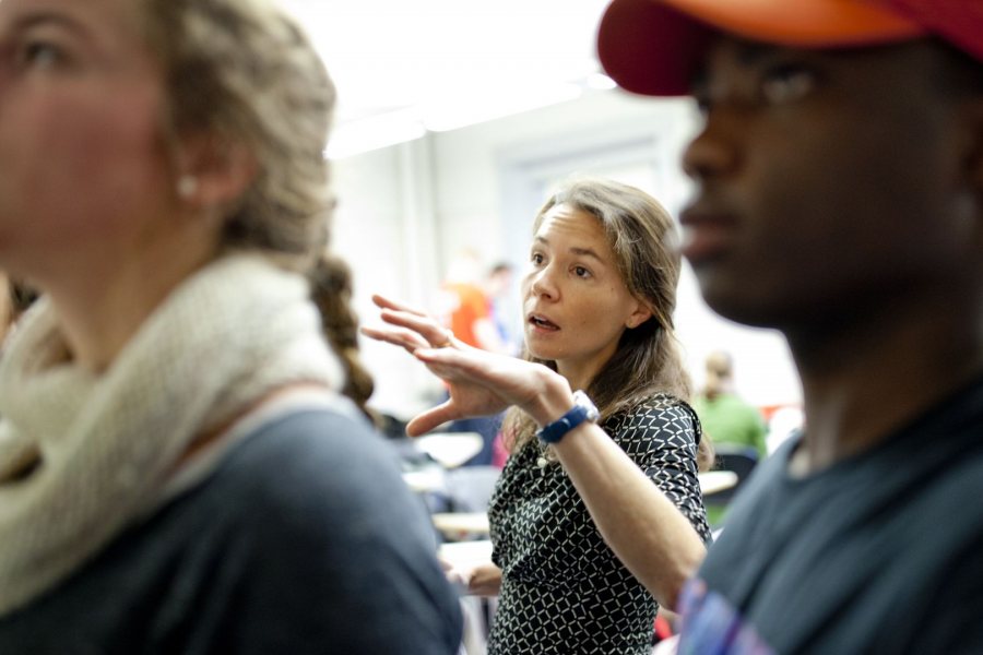 Assistant Professor of Education Mara Tieken circulates among small groups of students as they discuss what makes good teaching. Through fieldwork and classroom work, education students learn about the field’s interdisciplinary perspectives and the practical realities today. (Phyllis Graber Jensen/Bates College)